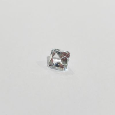 a close up of a square cut diamond on a white surface