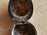 a silver locke with a picture of a woman in it