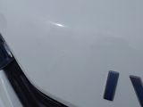 a close up of a white car with a v logo on it