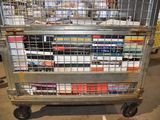 a metal cart with many books on it in a warehouse
