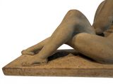 a statue of a woman laying down on the ground