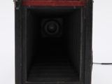 a black and red speaker that is on a white surface
