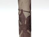 a vase that has a flower on it on a table
