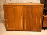 a wooden cabinet with two doors and a television on it