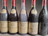 several bottles of wine are lined up on a table