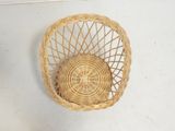 a small wicker basket hanging on the wall