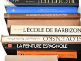 several books are stacked on top of each other on a shelf