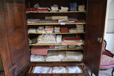a large wooden cabinet with many items in it