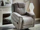 a recliner chair in a living room with a fireplace in the background