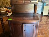 a wooden cabinet in the middle of a room