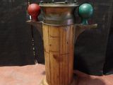 a wooden stand with a metal pot on top of it