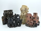 four different vases are sitting next to each other on a white surface
