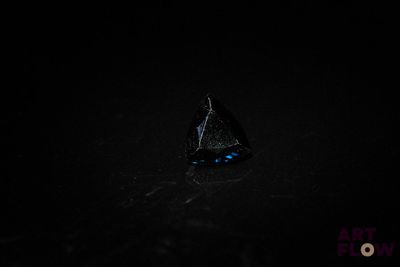 a close up of a black diamond in the dark