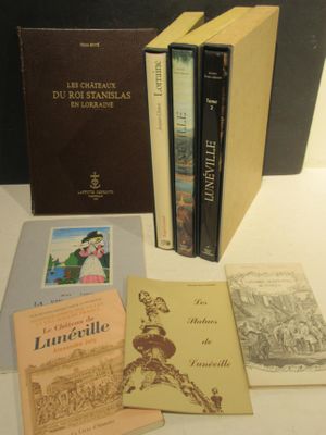 several books are sitting on a table next to each other