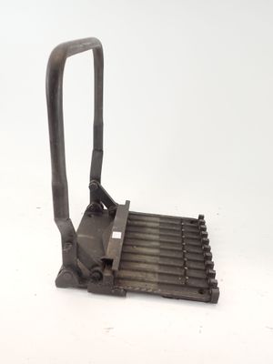 a metal grater with a handle on a white surface