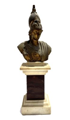 statue of a bust of a man with a hat on top of a pedestal