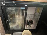a glass door that is open to show bottles of wine