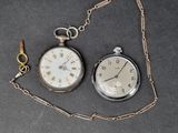 two different types of pocket watches on the table