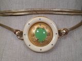 a close up of a belt with a green heart on it