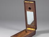 an old wooden box with a mirror on top of it