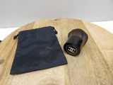 a black bag and a black brush on a wooden table