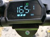 a digital clock on the handlebar of a bike