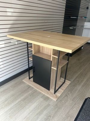 a wooden table with a black cabinet underneath it