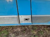 a close up of a blue and white bus door