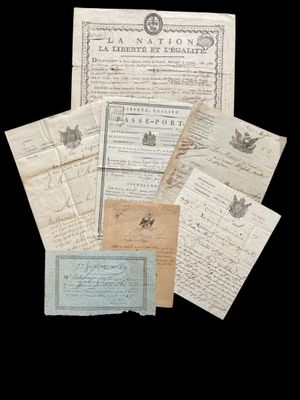 a pile of old letters and papers on a black background