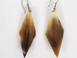 a pair of brown and white earrings on a white surface