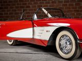 a red and white car parked in front of a brick wall