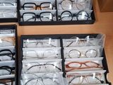 many pairs of glasses sitting in a box on a table
