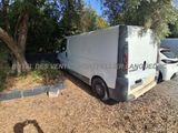 the van is parked on the side of the road next to a tree