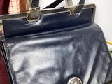 a black purse that is sitting on a table