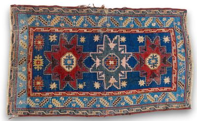 a blue and red rug with a design on it