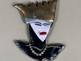 a picture of a brooch of a woman with a crown on her head