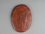 a brown plaque with a picture of a horse on it