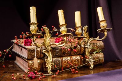 three candles that are sitting on top of a book
