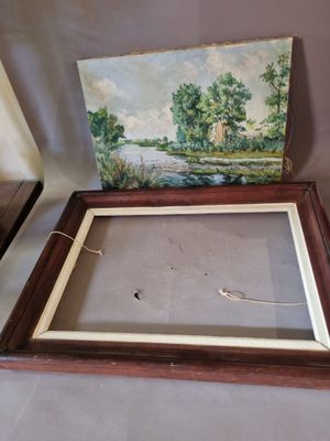 two framed paintings of trees and a river in a wooden frame