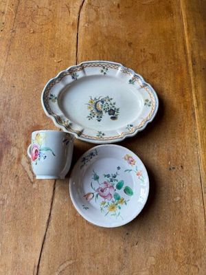 two plates and a bowl on a wooden table