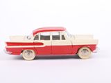 a red and white toy car on a white surface