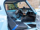 a close up of a car ' s interior with the door open