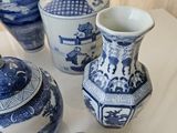 several blue and white vases are sitting on a table