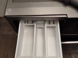 an open drawer with a vacuum on top of it