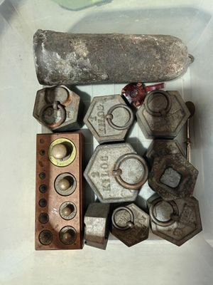 many nuts and bolts in a container on a table