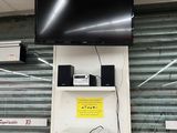 a television mounted on a wall above a microwave