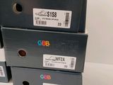 three boxes of shoes are stacked on top of each other