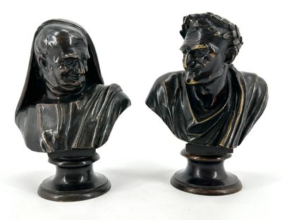 pair of black marble busts of a man and a woman