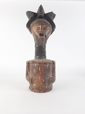 an old wooden sculpture of a man with a hat on his head