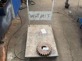 a picture of a machine shop with a gear wheel on it